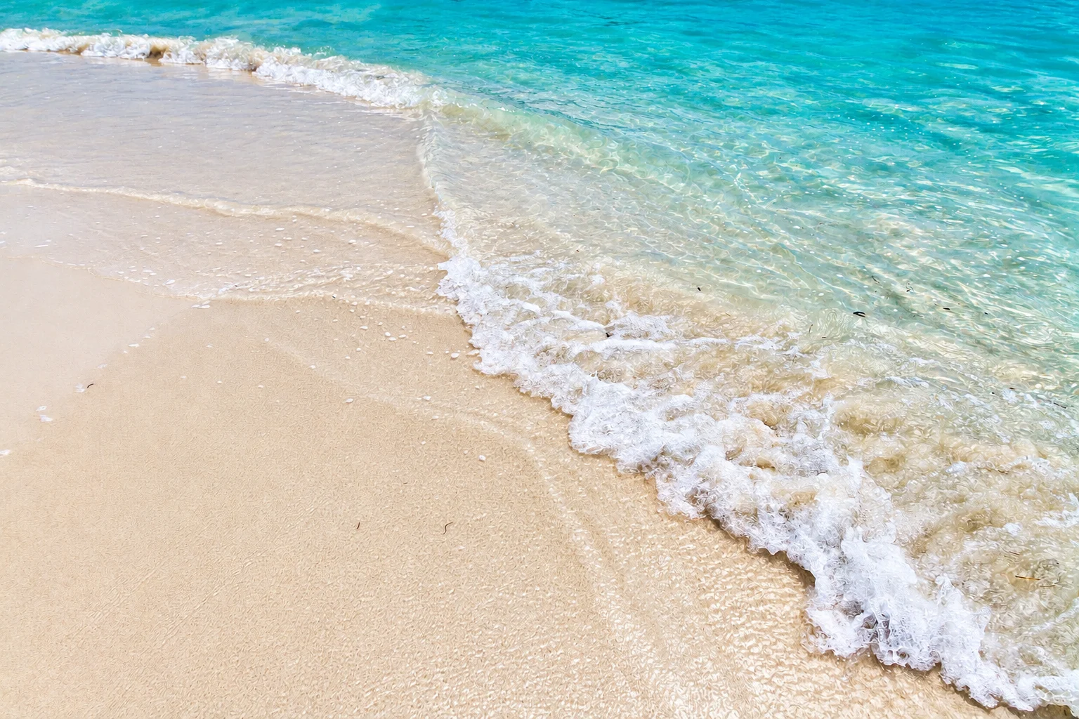 A gentle wave washing over pale sand — Cayo Levantado, AI-enhanced archival photograph
