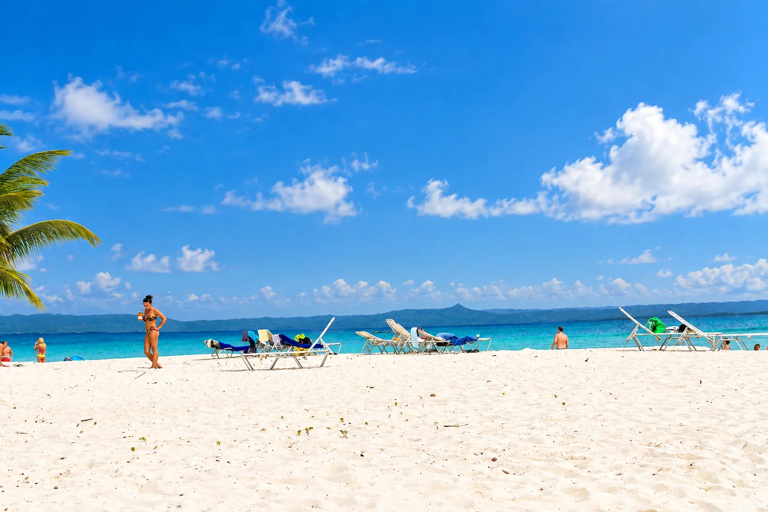 Open beach sand with loungers facing the sea — Cayo Levantado, AI-enhanced archival photograph